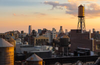 Summer Sunset light on Chelsea rooftops with water towers, Manha